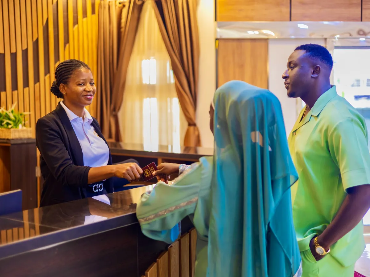 Receptionist welcoming guests at Diplomat Enclave Suites in Abuja